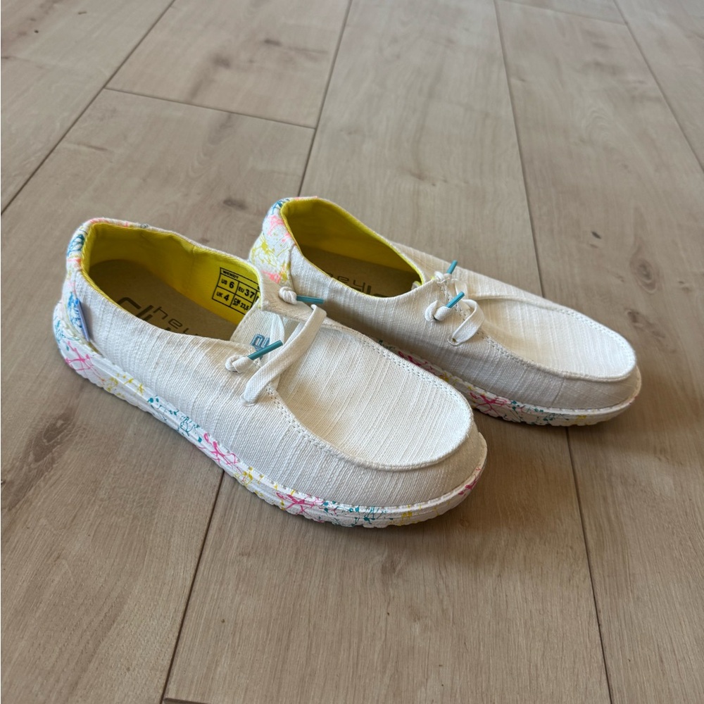 Hey Dude Women’s White Sneakers with graffiti colored heels. Brand New!